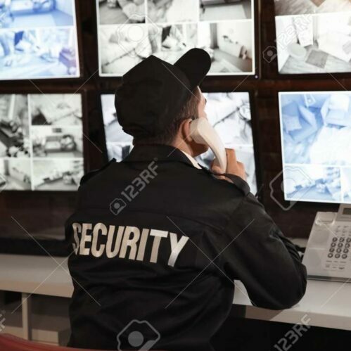 Male security guard talking by telephone in surveillance room – Red ...